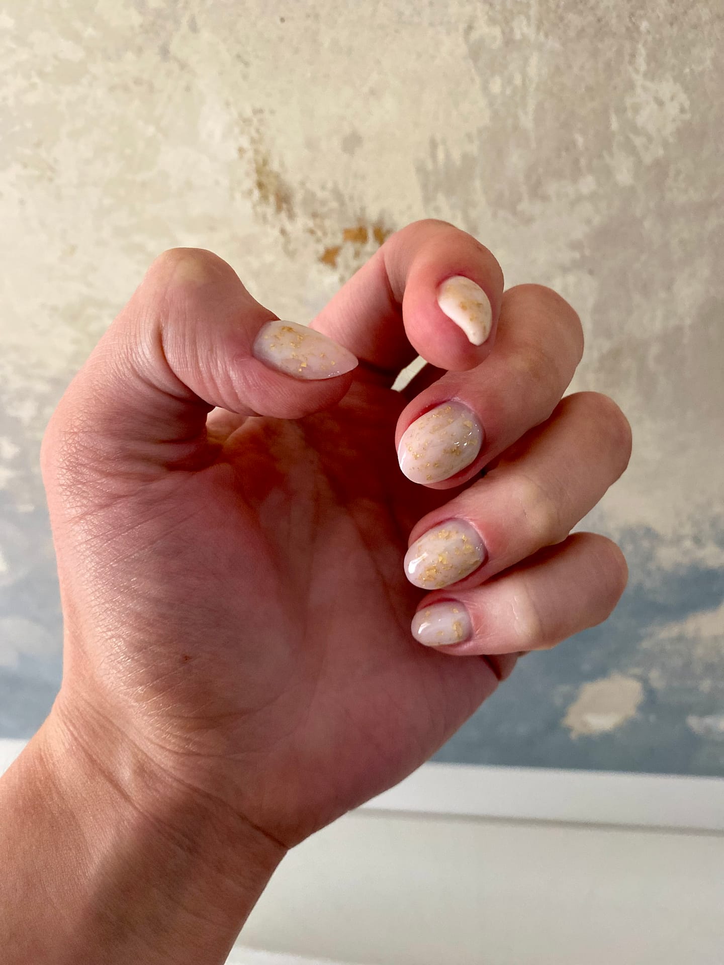 White Russian manicure with gold flakes