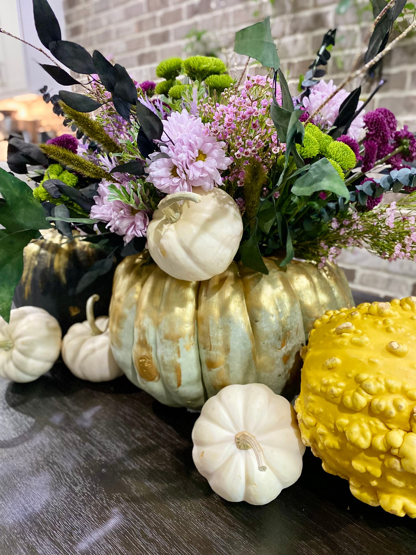 Bouquet made from store-bought flowers in a painted pumpkin. 