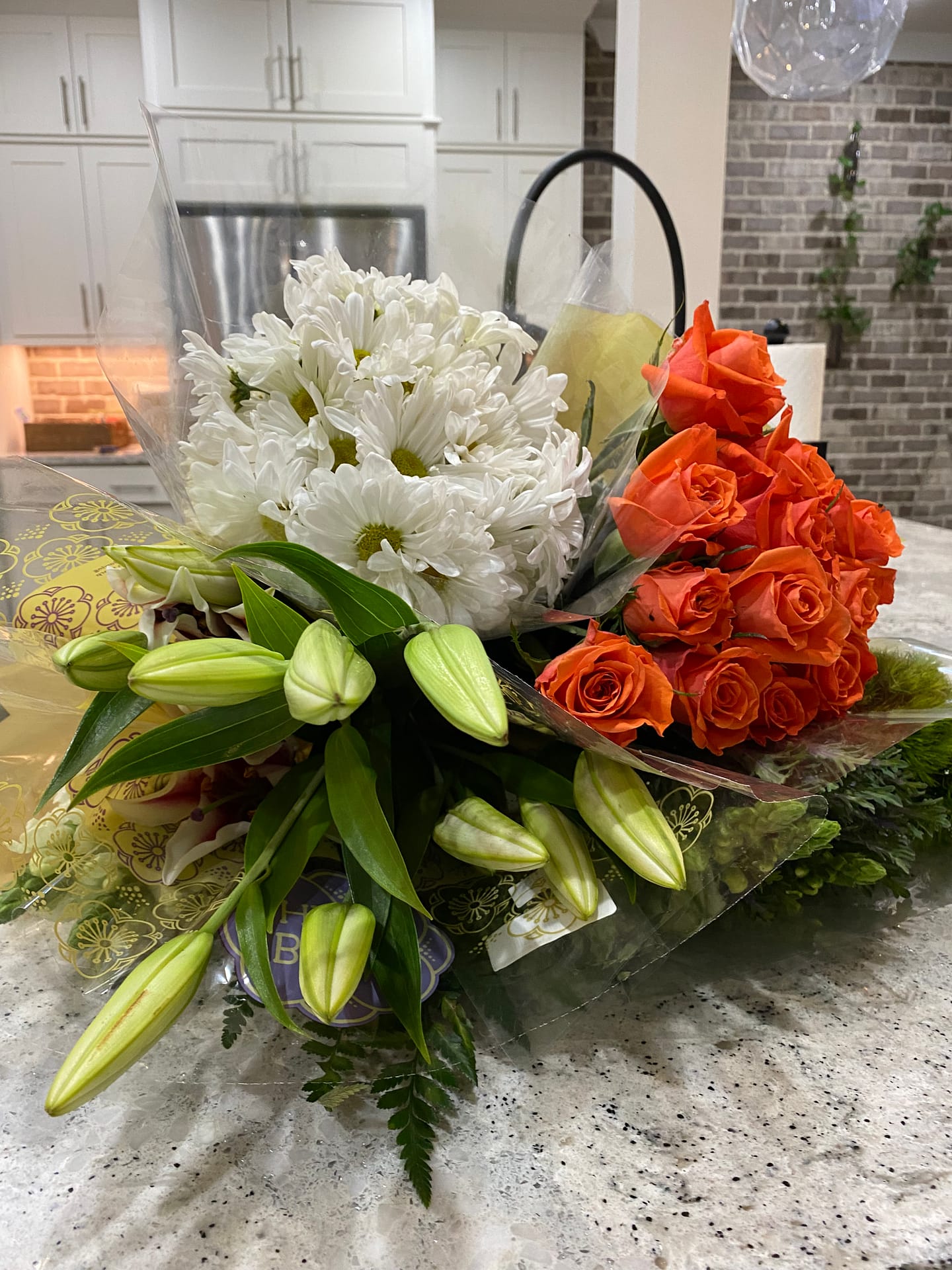 Orange roses and white daisies purchased from a grocery store. 